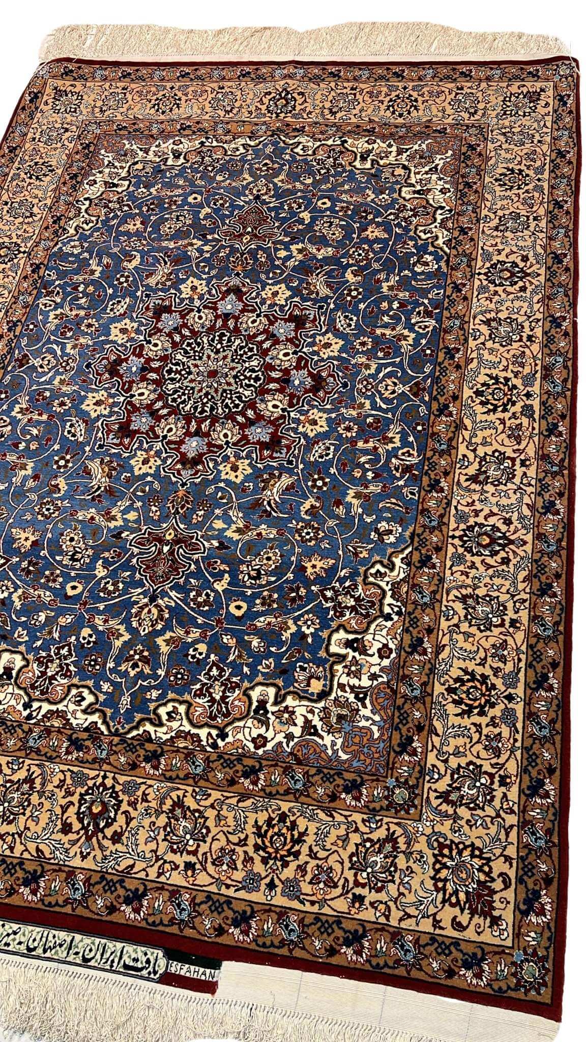 "Detailed close-up of the floral patterns on a Seirafian Persian rug, showcasing hand-knotted wool and silk craftsmanship from Isfahan, Iran."
